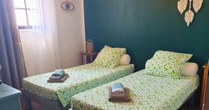 two beds with shoes on them in a room at Minavita - Vue mer, Plage à pied, Ruppione, Corse in Pietrosella