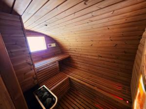 an inside of a wooden sauna with a window at Salaš Syrex in Zázrivá +201 photos