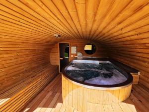 a jacuzzi tub in a wooden building at Salaš Syrex in Zázrivá