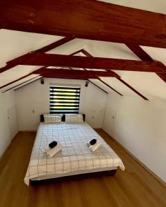 a bedroom with a large bed in a attic at Kuća za odmor Nera in Hadžići +19 photos