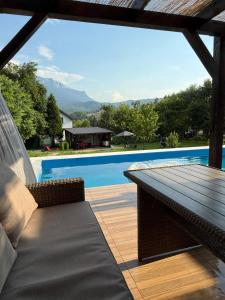 a patio with a table and a swimming pool at Kuća za odmor Nera in Hadžići