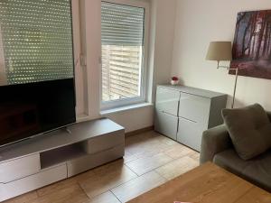 a living room with a flat screen tv and a couch at Schönwalde B in Siedlung Schönwalde
