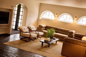 a living room with a couch and chairs and a tv at Josty Frederiksberg in Copenhagen