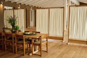 a dining room with a table and chairs and curtains at Josty Frederiksberg in Copenhagen