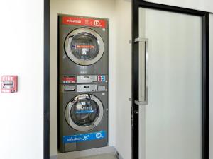a washer and dryer in a room at HOP INN Phetchaburi in Phetchaburi