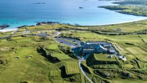 an aerial view of a golf course next to the ocean at 14 Leitirshask, Ballyconneely in Ballyconneely