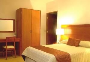 Postel nebo postele na pokoji v ubytování Hotel Marllou
