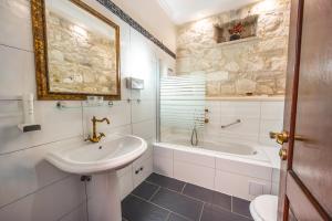 a bathroom with a sink and a toilet and a tub at Heritage Boutique Hotel Adriatic-Adults only in Orebić +72 photos