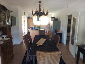 a dining room with a table and chairs in a kitchen at Huis bij basel in Hésingue
