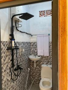 a small bathroom with a toilet and a sink at Sabin view homestay in Banyuwangi