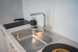 a stainless steel sink in a small kitchen at Studios Kerasioti in Pefki +24 photos