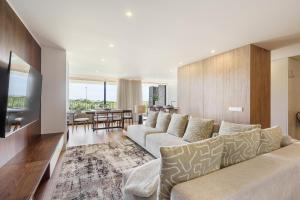 a living room with a large couch and a dining room at Seaside Beach Condo by Minho's Guest in Apúlia +22 photos