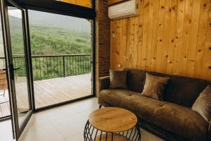 a living room with a couch and a table and a balcony at Casa Monti in Ijevan