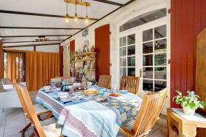 a dining room table with a blue and white table cloth at Chambres D'hôtes Le Peux in Saint-Pierre-le-Vieux +28 photos