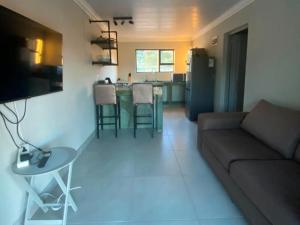 a living room with a couch and a table at Springbok Guest Farm in Springbok