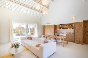 a living room with a white couch and a table at Quinta Amala in Melides