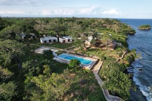 an aerial view of a house with a swimming pool at Kasa Pomboo Hotel, Shimoni in Shimoni