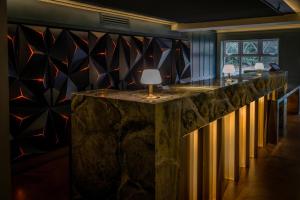 a lobby with a stone counter with lamps on it at Best Western Abbots Barton Hotel in Canterbury