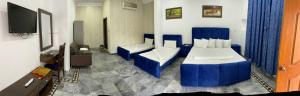 a hotel room with a bed and a tv at Hotel Royal Luxury Multan in Multan