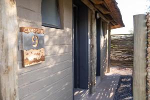 a sign on the side of a building at Palmwag Campsite in Palm