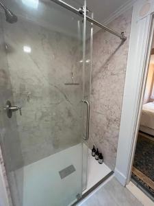 a shower with a glass door in a bathroom at Cheney House Bed & Breakfast in Ashland +48 photos