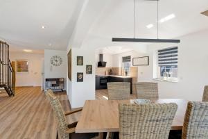 a dining room and living room with a table and chairs at Ferienwohnung "Am Waldrand" in Bottrop