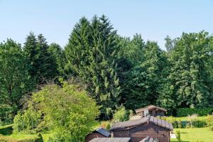 a building in a field with trees in the background at Ferienwohnung "Am Waldrand" in Bottrop