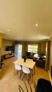 a living room with a table and a couch at Die Kothuis in Wolseley