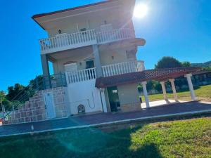 a house with a swimming pool in front of it at Olive Tree Villa in Preveza +8 photos