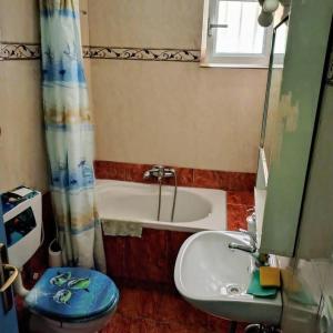 a bathroom with a toilet and a sink and a tub at Olive Tree Villa in Preveza
