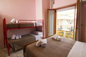 a room with two bunk beds and a balcony at Hotel Roma in Pineto +5 photos