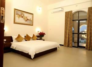 a bedroom with a bed and a window at The Emerald Palace in Sehore