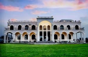 a large white house with a large yard at The Emerald Palace in Sehore