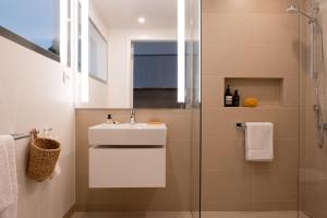 a bathroom with a sink and a shower at THE FLAG Lugano - Self Check-in in Massagno +21 photos