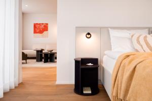 a bedroom with a bed and a living room at THE FLAG Lugano - Self Check-in in Massagno