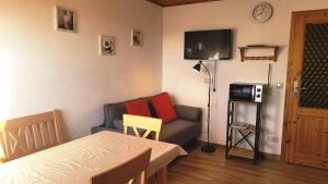 a room with a bed and a couch and a tv at Bauernhof Nißl in Neunburg vorm Wald