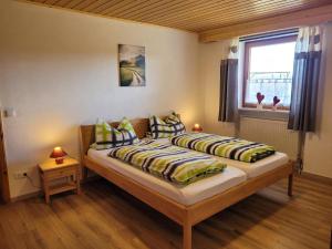 a bedroom with two beds and a window at Bauernhof Nißl in Neunburg vorm Wald