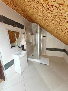 a white bathroom with a sink and a shower at Zacisze Grojeckie in Grojec +32 photos
