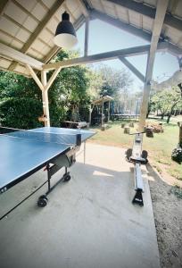 a ping pong table in a pavilion with a ping pong ball at Káli44 Vendégház in Révfülöp