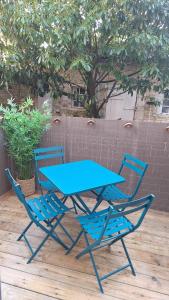 a blue table and chairs on a wooden deck at Libre comme l'air - Appartement - Terrasse - 1 Chambre in Ruffec