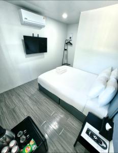 a hotel room with a bed and a tv at Cloud Bed Ao Nang- High Speed internet, Comfort bed , Smart Tv in Ao Nang Beach