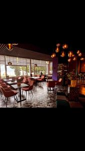 a restaurant with tables and chairs in a room at Hotel Parc & Lac in Montreux