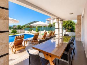 a dining room with a table and chairs and a swimming pool at Villa Ozcelik in Dalyan