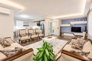 a living room with couches and a tv at Villa Ozcelik in Dalyan