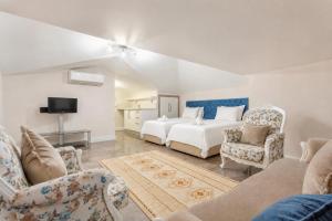 a bedroom with a bed and a couch and a tv at Villa Ozcelik in Dalyan