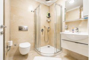 a bathroom with a shower and a toilet and a sink at Villa Ozcelik in Dalyan +16 photos