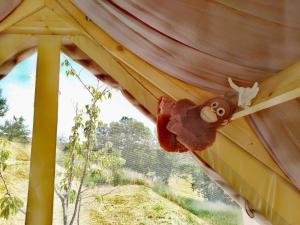 a stuffed monkey hanging from the ceiling of a tent at Glamping Casacocco' in San Ginesio