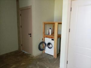 a laundry room with a washing machine in a room at IO House in Urekis Sadguri
