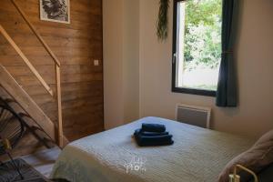 a bedroom with a bed and a stair case at Chalet tous confort avec piscine lagon in Vallon-Pont-dʼArc