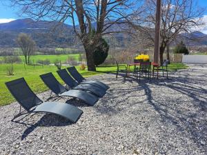 a group of chairs and a table in a field at le Cocon in Montgardin